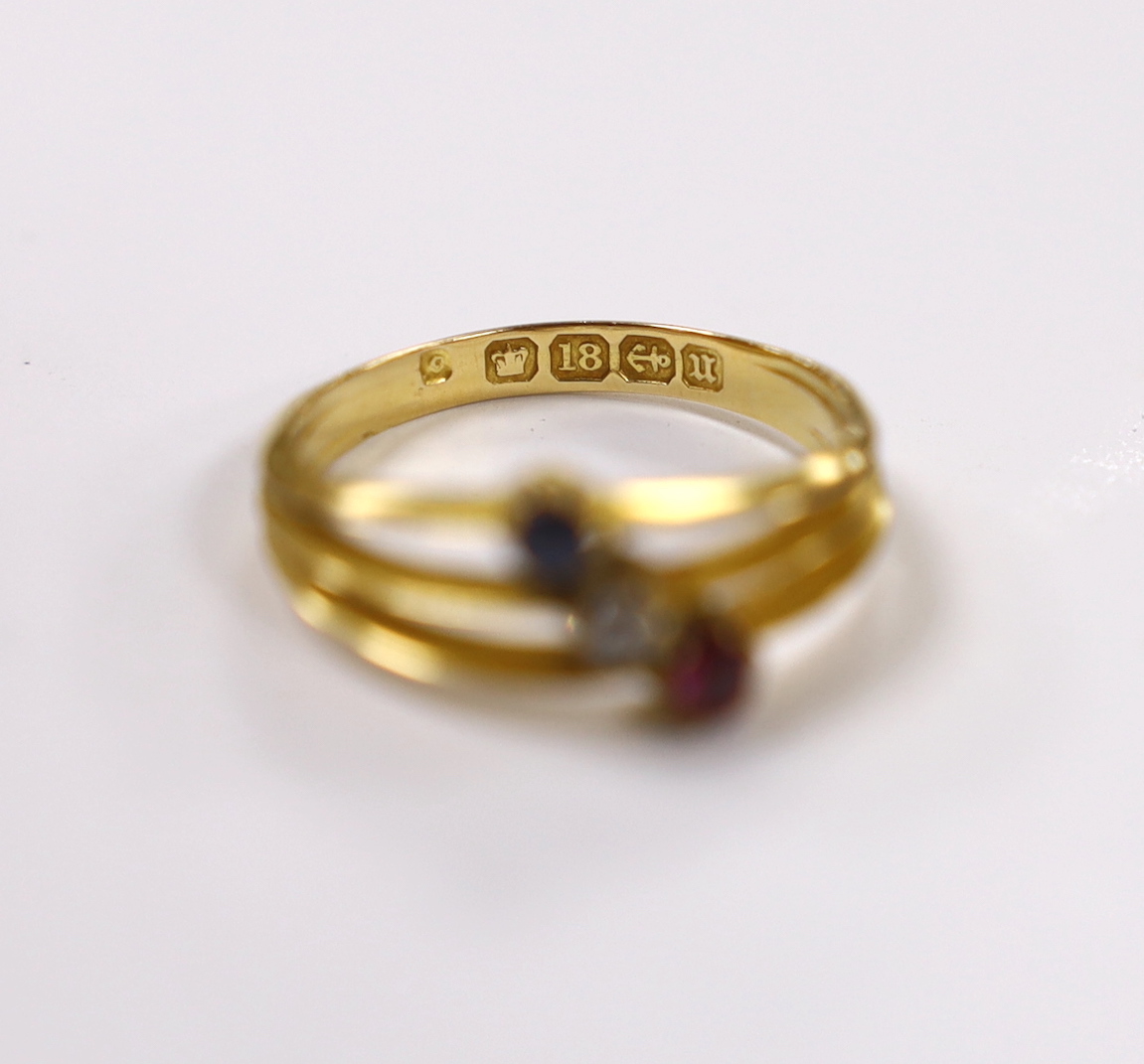 A late Victorian 18ct gold, sapphire ruby and diamond set three stone triple shank ring, size N, gross weight 2.9 grams.